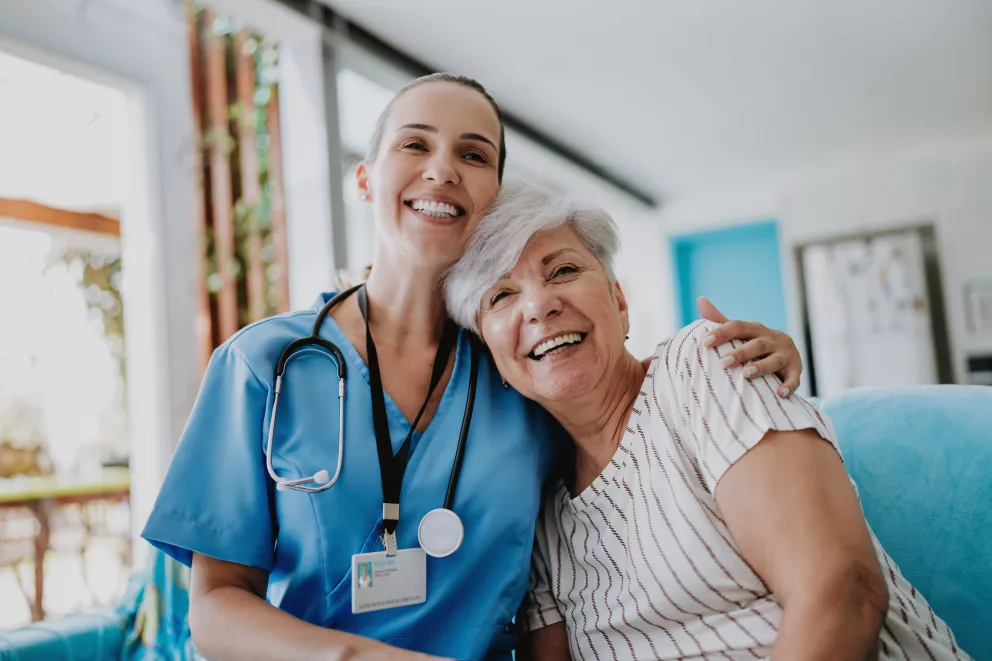 Healthcare employee hugging a patient.